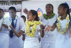  ??  ?? Once a year, the churches of American Samoa celebrate White Sunday, and all the children dress in white and memorize Bible passages.