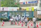  ?? PTI ?? Employees queue up to enter Maruti Suzuki India's Manesar plant, which resumed operations after around 40 days of closure due to the Coronaviru­s-led lockdown, near Gurugram in Haryana, on Tuesday