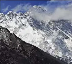  ??  ?? NEPAL: In this photograph Mount Everest (Background) and the Nupse-Lohtse massif (Foreground) are seen from the village of Tembuche in the Kumbh region of north-eastern Nepal.—AFP