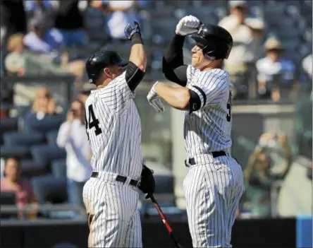  ?? PHOTOS BY SETHWENIG — THE ASSOCIATED PRESS ?? New York Yankees’ Aaron Judge, right, celebrates his two-run homer with Gary Sanchez during the third inning of a baseball game against the Kansas City Royals at Yankee Stadium, Monday, Sept. 25, 2017, in New York. It was Judge’s 49th home run, which...