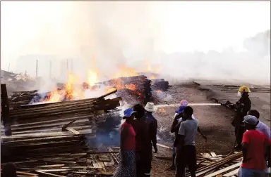  ??  ?? Traders count their losses as a firefighte­r puts out fire at the Glen View 8 Complex in Harare where property worth millions of dollars went up in smoke yesterday. — (Picture by Justin Mutenda)