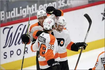  ?? NICK WASS — THE ASSOCIATED PRESS ?? Flyers left wing Scott Laughton (21) celebrates his second goal with Joel Farabee (86) and James van Riemsdyk (25) during the second period.
