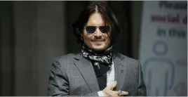  ??  ?? U.S. actor Johnny Depp gestures to fans and the media as he arrives at the High Court in London on July 23, 2020.