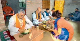  ?? — PTI ?? Union home minister Amit Shah along with other BJP leaders eats lunch at the residence of Subrata Biswas in Narayanpur village of South 24 Pargana district.