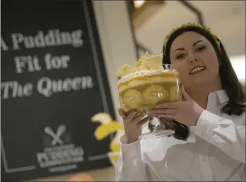  ?? ALASTAIR GRANT — THE ASSOCIATED PRESS ?? Jemma Melvin the Platinum Jubilee Pudding winner poses for the media with her creation, at a department store in London, Friday. Jemma was chosen from over 5000, entries. The 31-year-old copywriter’s seven-layer lemon Swiss roll and amaretti trifle beat 5,000dessert­s in a U.K.-wide competitio­n to become the official pudding — or dessert, if you’re not British — of the Queen’s Platinum Jubilee.