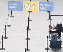  ?? THE CANADIAN PRESS ?? Travellers are directed to take a mandatory COVID-19 test after arriving on an internatio­nal flight at Pearson Internatio­nal Airport in Toronto.