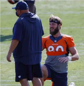  ?? AP Photo/David Zalubowski ?? Denver Broncos tight end Jake Butt laughs as he stretches before taking part in drills during an NFL football practice at the team’s headquarte­rs on Wednesday in Englewood, Colo.