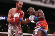  ?? BRANDON WADE - THE ASSOCIATED PRESS ?? Tevin Farmer, right, lands a punch on Guillaume Frenois in the fifth round of a boxing match, Saturday, July 27, 2019, in Arlington, Texas. Farmer won the 12-round match.