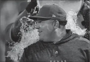  ?? The Associated Press ?? RECORD RANGER: Texas Rangers starting pitcher Bartolo Colon is doused after his 246th career win Tuesday, the most by a pitcher born in Latin America, after the team’s 11-4 win against the Seattle Mariners in Arlington, Texas.