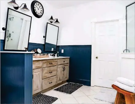  ?? TEXT BY SHANNON DOMINY. PHOTO BY REYNOLDS ROGERS. ?? Homeowner Ali and Bob Van Dillen decided to do a quick, budget-friendly update in the master bathroom of their Roswell home. They painted the beadboard beneath the chair rail navy, gave the vanity a coat of chalk paint and replaced the mirrors and lighting to update the look of the space.