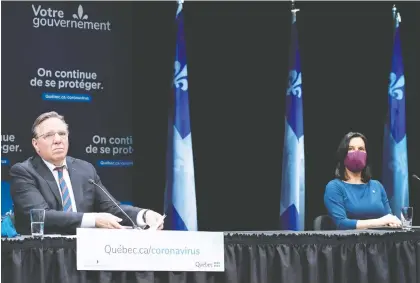  ?? PAUL CHIASSON/THE CANADIAN PRESS ?? Quebec Premier François Legault and Montreal Mayor Valérie Plante practised proper social distancing during Legault’s daily briefing on the coronaviru­s pandemic at Place des Arts on Thursday. It marked the premier’s first visit to Montreal in two months.