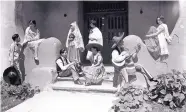  ?? COURTESY OF NEW MEXICO MUSEUM OF ART ?? Santa Fe Fiesta celebrants gather at the steps of the New Mexico Museum of Art in this historic photograph, probably taken sometime between 1925 and 1945.