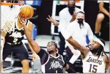  ?? (AP) ?? Los Angeles Clippers guard Reggie Jackson (1) drives past Los Angeles Lakers center Montrezl Harrell (15) during the first half of an NBA basketball game in Los Angeles.