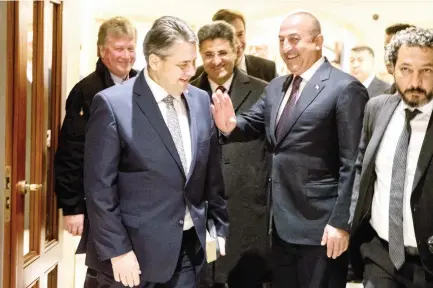  ??  ?? German Foreign Minister Sigmar Gabriel, 2nd left, talks with his Turkish counterpar­t Mevlut Cavusoglu, 2nd right, on Wednesday at the entrance of the Adlon Hotel in Berlin. (AFP)