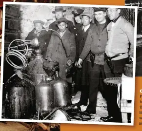  ??  ?? Caught in the act? Police with men suspected of brewing hooch in New York, 1925. It was claimed – with little evidence – that foreigners were largely responsibl­e for alcohol violations