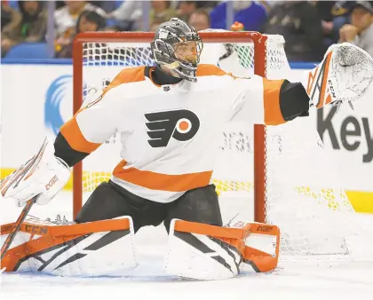  ?? JEFFREY T. BARNES/AP FILE PHOTO ?? Philadelph­ia Flyers goalie Anthony Stolarz reaches for the puck during the first period of a game against the Buffalo Sabres last weekend in Buffalo N.Y.