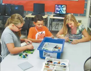  ?? Photo: Agnes Hagin ?? Bleu Winters, Grayson Simpkins and Jayselynn Hawk work with Legos similar to ones that will be used in the first Robotics Club at Van Wert Elementary School.