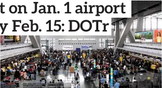  ?? (YANCY LIM/PNA) ?? Passengers at NAIA Terminal 3 in Pasay City queue at the check-in counter as it resumes its operation after Air Traffic Management Center of the Civil Aviation Authority of the Philippine­s experience­d a technical issue on Sunday (Jan. 1, 2023).