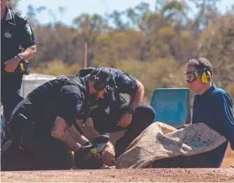  ??  ?? Police cut Adani activist Benjamin Roy Winch free after he locked himself to a cattle grid.