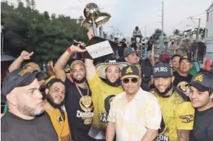  ??  ?? Festejos. Juan Carlos Pérez levanta el trofeo de campeón, rodeado de jugadores del equipo de las Águilas y el presidente del club, Winston Chilote Llenas, durante la caravana para festejar el triunfo.