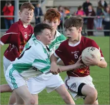  ??  ?? Jack O’Gorman of Castletown comes under pressure from Matthew Bishop (Crossabeg-Ballymurn).