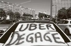  ?? Christine Poujoulat / AFP / Getty Images file ?? A taxi with a banner that reads “Uber get out” is seen during a 2015 protest in the southern French city of Marseille. A key European official said Tuesday that the ride-hailing service should have to abide by rules governing taxi services.