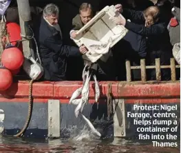  ??  ?? Protest: Nigel Farage, centre, helps dump a container of fish into the Thames