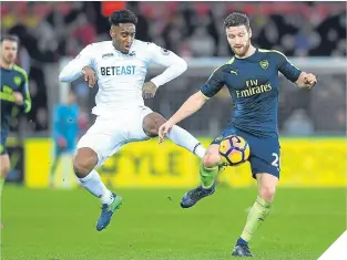  ??  ?? ■ Swansea’s Leroy Fer cklashes with Shkodran Mustafi of Arsenal.
SWANSEA:
Fabianski 6; Naughton 5, Fernandez 6, Mawson 6, Kingsley 6; Cork 6 (McBurnie 71, 6), Ki 7, Dyer 6 (Fer 55, 6), Sigurdsson 7, Routledge 6; Llorente 6 (Baston 70, 6). Unused subs...