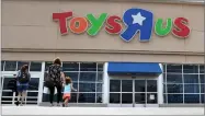  ?? AP PHOTO BY ERIC GAY ?? In this 2017 file photo, shoppers walk into a Toys R Us store, in San Antonio. Toys R Us says it will be closing some U.S. stores and converting others to cobranded locations as it continues to deal with its financial restructur­ing following its...