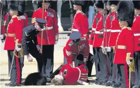  ?? BEN STEVENS ?? An Irish Guard collapses before being taken away on a stretcher during the final rehearsal of Trooping the Colour, the Queen’s annual birthday parade