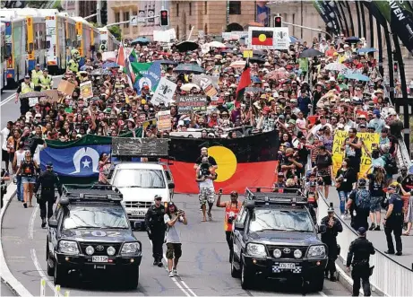  ?? PHOTO: AAP ?? ‘NATIONAL DISGRACE’: Hundreds of people march through Brisbane yesterday for the annual Invasion Day protest.