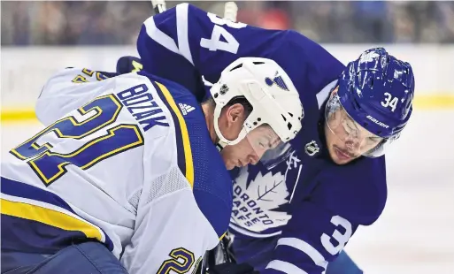  ?? FRANK GUNN THE CANADIAN PRESS ?? Ex-Leaf Tyler Bozak battles Auston Matthews in Saturday night’s contest at Scotiabank Arena, Bozak’s first game in Toronto as an opponent.