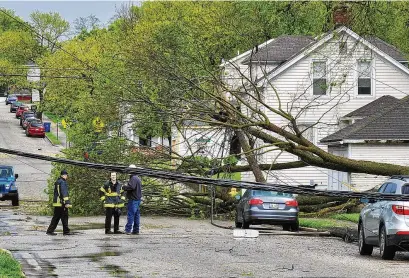  ?? NICK GRAHAM / STAFF ?? Trees and power lines were down at Liberty Avenue and North “F” Street after a storm swept through Hamilton around 3 p.m. Tuesday, but the winds were of the straight-line variety, the National Weather Service says.