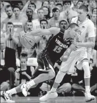  ?? AP/GERRY BROOME ?? Virginia’s Malcolm Brogdon (15) drives past North Carolina’s Justin Jackson during the first half of Monday’s game in Chapel Hill, N.C. Brogdon scored 17 points to lead the Cavaliers to a 75-64 victory.