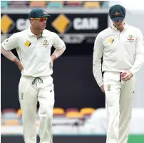  ?? AFP ?? Smith (right) and Warner were suspended from state and internatio­nal cricket for 12 months over ball tampering. —