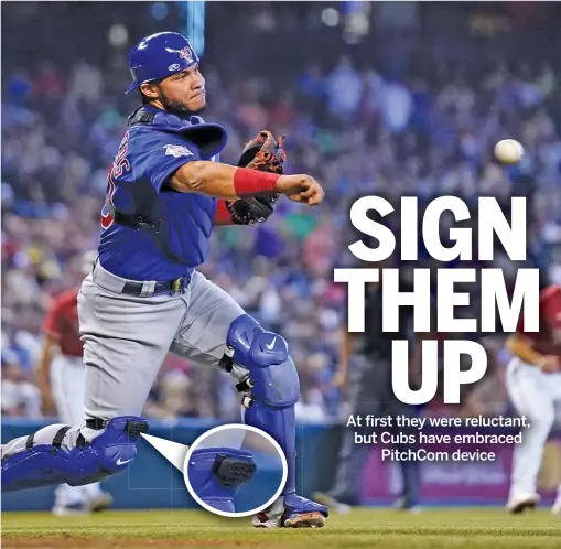  ?? ROSS D. FRANKLIN/AP ?? Various teams (top) have employed the new PitchCom technology, including the Cubs with catcher Willson Contreras (above). Some catchers have put the device on wristbands, but Contreras preferred to put it on his right shin guard (inset).