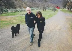  ?? Rich Pedroncell­i Associated Press ?? FORMER GOV. Jerry Brown and his wife, Anne Gust Brown, take a walk with their dog Cali at their Colusa County ranch near Williams, Calif.