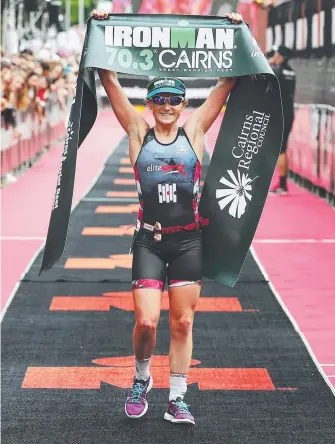  ?? Picture: BRENDAN RADKE ?? Madi Roberts crosses the finish line on the Cairns esplanade.