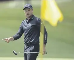  ?? ?? Main: Bryson Dechambeau hands his club to his caddie after putting on the first green. Above: Danny Willett is back in the groove following shoulder surgery. Below: Ryan Fox carded a three-under 69