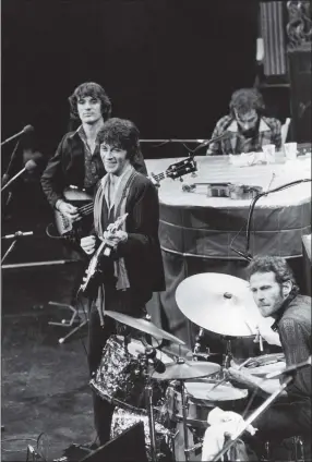  ?? JOHN STOREY ?? FILE - In this Nov. 27, 1976 file photo, The Band, Richard Manuel on piano, Levon Helm on drums, lead guitarist Robbie Robertson, center, and bass guitarist Rick Danko, take the stage for their final live performanc­e before a crowd of 5,000 at Winterland Auditorium in San Francisco. Roberston, 76, said in a recent interview that he was in a melancholy mood when he wrote the song, “”Once Were Brothers,” already looking backward on his life while he was helping create a new documentar­y on The Band.