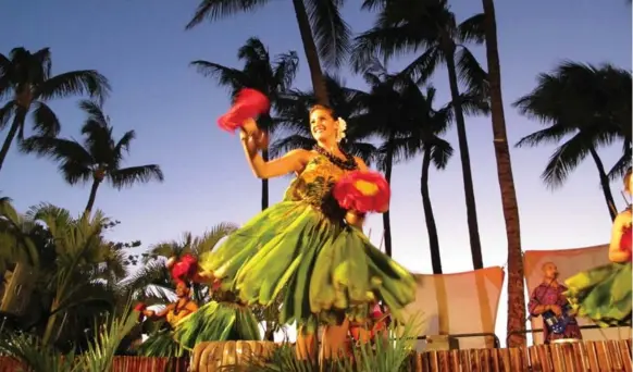  ?? JIM BYERS/TORONTO STAR ?? Nothing says Hawaii quite like a hula dancer at a sunset luau under the palm trees. The luau they put on at the Westin Maui at Ka’anapali Beach is one of the best in the state.