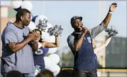  ?? JOE HERMITT — PENNLIVE.COM VIA AP ?? Former Penn State defensive lineman Jimmy Kennedy, left, watches as Bryant Johnson speaks at the Fiesta Bowl pep rally in Scottsdale, Ariz., Friday. Penn State is to play Washington on Saturday.