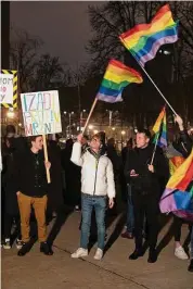  ?? Marko Drobnjakov­ic / Associated Press ?? People wave rainbow flags as they attend a LGBTQ rights protest in central in Belgrade, Serbia, Friday. Local LGBTQ rights activists organized a protest after a gay person was attacked and gravely injured in the Serbian capital.