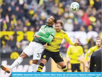  ??  ?? DORTMUND: Dortmund’s German midfielder Mario Goetze (R) and Hanover’s Nigerian midfielder Noah Joel Sarenren Bazee vie for the ball during the German first division Bundesliga football match. — AFP