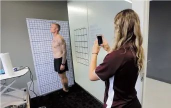  ??  ?? Former NFL football player Nick McDonald (left) poses for a picture during an evaluation with Krysten McCaughey at Exos. McDonald played for the Green Bay Packers, New England Patriots, San Diego Chargers and Cleveland Browns during his time playing football in the NFL. — IC