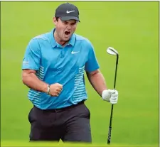  ?? JASON GETZ/ATLANTA JOURNAL-CONSTITUTI­ON VIA AP ?? Patrick Reed celebrates his eagle chip on No. 15 during the third round of the Masters on Saturday. Reed shot a five-under 67 and leads Rory McIlroy by three heating into today’s final round.