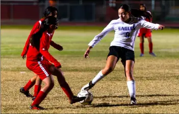  ?? PHOTO VINCENT OSUNA ?? Southwest High’s Veronica Saavedra (right) works for possession of the ball against a pair of defenders during the Eagles’ away league game against imperial High on Tuesday night at Shimamoto-Simpson Stadium in imperial.