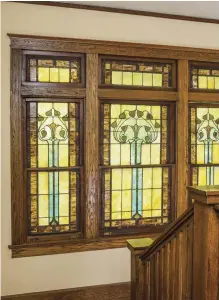  ??  ?? ABOVE While the stained-glass windows in the rest of the house are decidedly Arts &amp; Crafts, the three-part window above the stair landing has the sinuous curves of Art Nouveau. This window may have been made in Chicago. LEFT A swing hangs on the porch, a pleasant perch for resting and watching passersby. TOP An early project was to accentuate exterior forms, emphasizin­g the horizontal banding and making visible the quoins, beadboard soffits, and dormer.