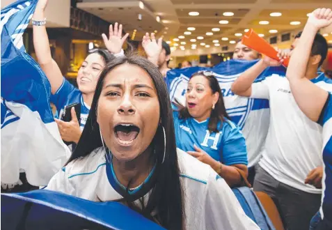  ?? Picture: JENNY EVANS ?? FEVER-PITCH: Honduras fans give their football team a memorable welcome at Sydney airport yesterday.