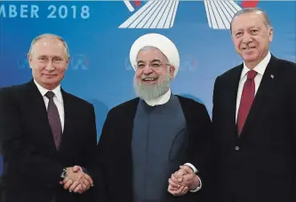  ?? THE ASSOCIATED PRESS ?? Iran's President Hassan Rouhani, flanked by Russia's President Vladimir Putin and Turkey's President Recep Tayyip Erdogan, were photograph­ed in Tehran, Iran, ahead of their summit Friday to discuss Syria.